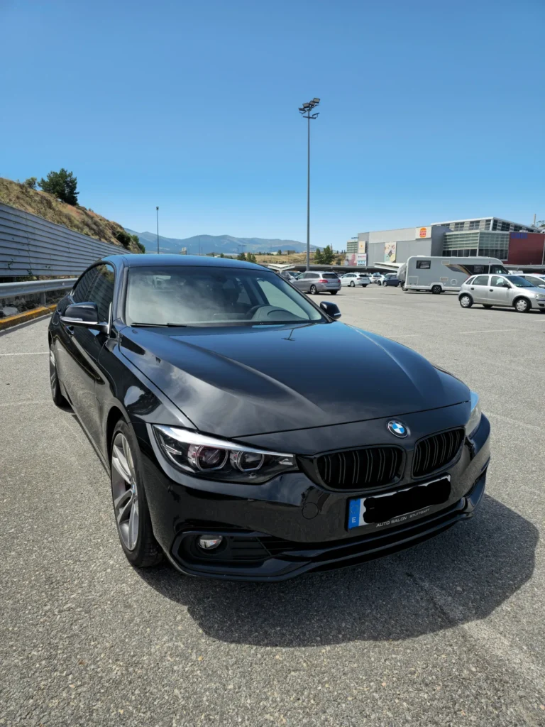 BMW Serie 4 negro en vista frontal tres cuartos en un aparcamiento